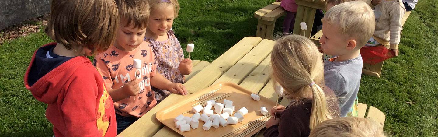 Photo: children outside at Kiddlywinks Nursery, Penrith